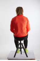   Erling  1 black pants dressed orange long sleeve t shirt sitting sports whole body yellow sneakers 0003.jpg